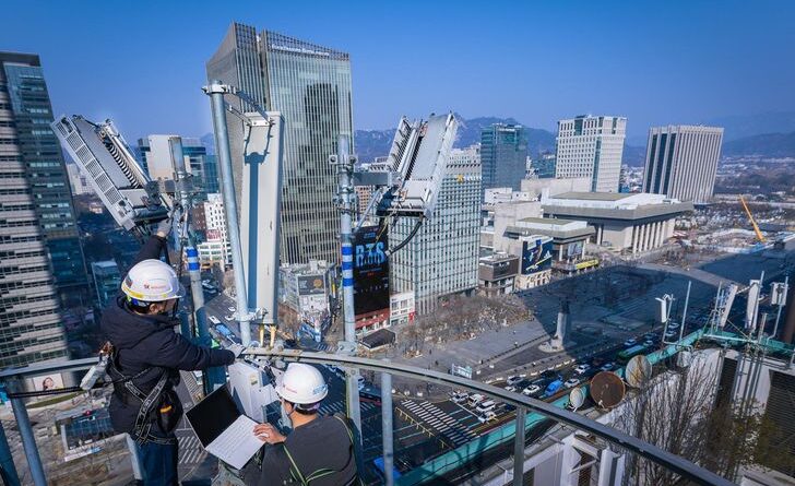 Engineers testing 5G equipment at Gwanghwamun Square AI Invisible Infrastructure: A heat map of expected data usage for the BTS concert; The BTS Arirang album logo.