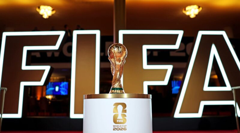 Joachim Löw speaking at a press event, German World Cup MediaXTrand, the 2026 World Cup trophy with a background of the US, Mexico, and Canada flags; Military security in Mexico City.