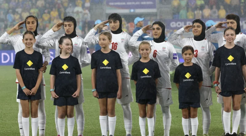 Iranian women's football team standing in silence; David Seymour during a press conference; Protesters outside the Robina Stadium.