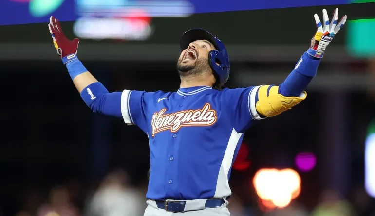 Eugenio Suarez celebrating the winning run; Venezuela stuns USA; MediaXTrand; Bryce Harper's 8th-inning home run; Fans waving Venezuelan flags at LoanDepot Park.