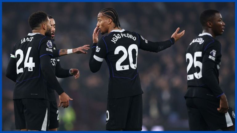 Joao Pedro celebrating his second goal at Villa Park; Enzo Fernandez pointing toward the Chelsea fans; Liam Rosenior on the touchline.