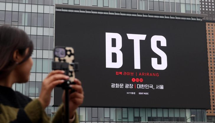International fans holding BTS lightsticks at Gwanghwamun; MediaXTrand; BTS comeback; An arrival board at Incheon International Airport showing 2026 dates; The Korea Tourism Organization logo.