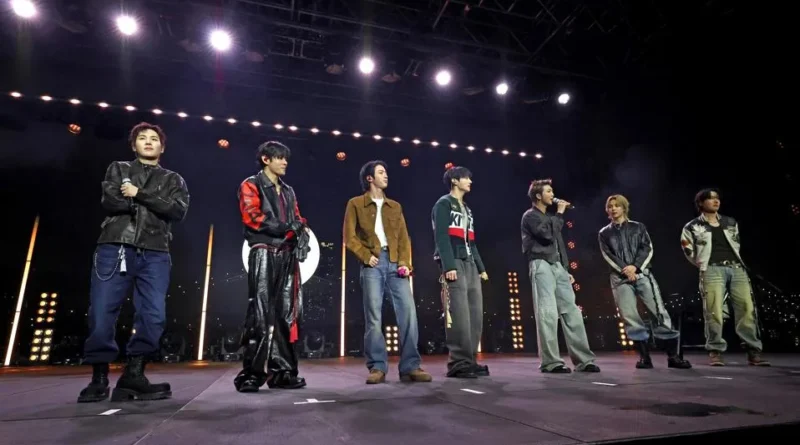BTS performing live on stage during a concert after dominating the UK music charts
